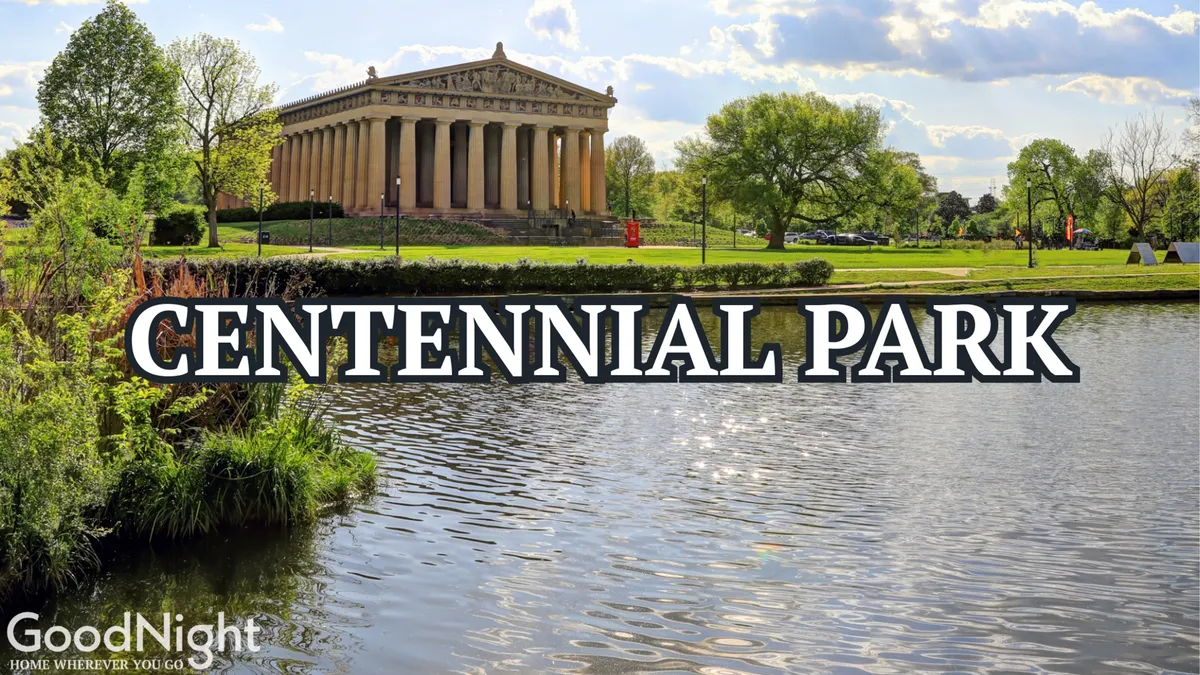 A sweeping view of Centennial Park with the iconic Parthenon prominently featured, surrounded by lush greenery, reflective water, and open park space. The tranquil setting is perfect for strolling, picnicking, and enjoying nature amid urban Nashville.